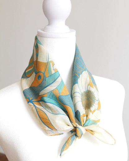 Toucan in Floral Jungle Bandana Scarf on mannequin, showcasing vibrant colors and tropical design details. Perfect summer accessory.