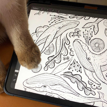 Close-up of a digital drawing of humpback whales, featuring detailed line art, with a cat's paw in the foreground.