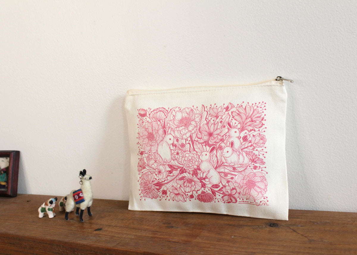 Bunny in the Floral Breeze canvas zipper pouch featuring floral art, perfect for cosmetics and small essentials.