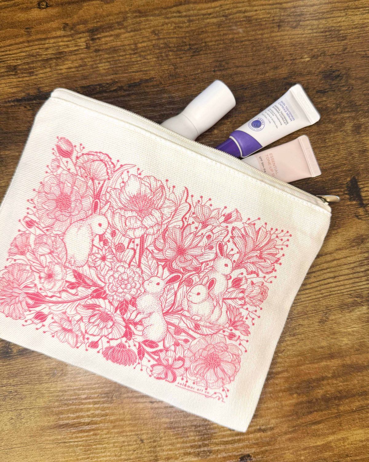 Bunny in the Floral Breeze canvas zipper pouch with floral design, perfect for cosmetics or small belongings.