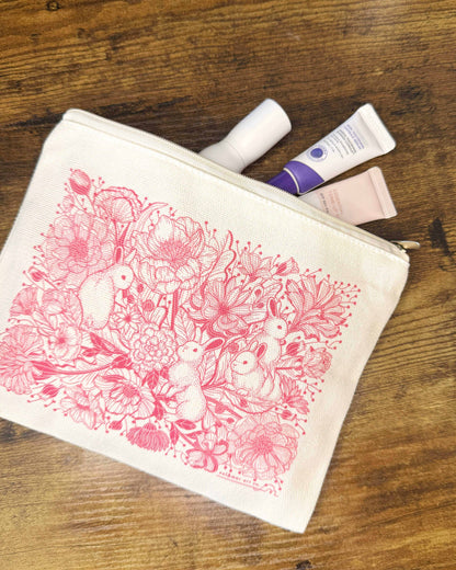 Bunny in the Floral Breeze canvas zipper pouch with floral design, perfect for cosmetics or small belongings.