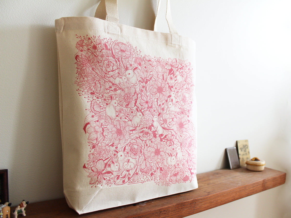 Bunny in the Floral Breeze canvas tote bag featuring whimsical rabbit and flower artwork, perfect for everyday use.