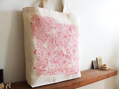 Bunny in the Floral Breeze canvas tote bag featuring whimsical rabbit and flower artwork, perfect for everyday use.