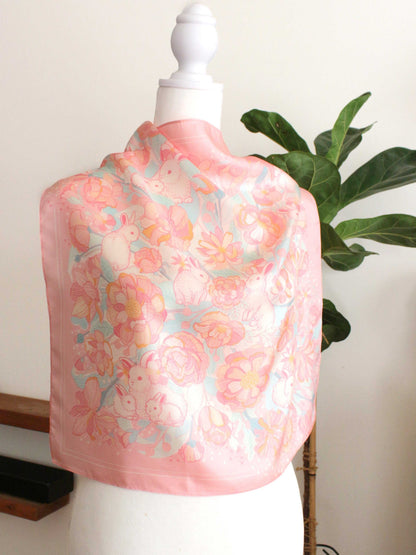 Bunny in the Floral Breeze Silk Twill Scarf draped on a mannequin, showcasing floral and rabbit art design.