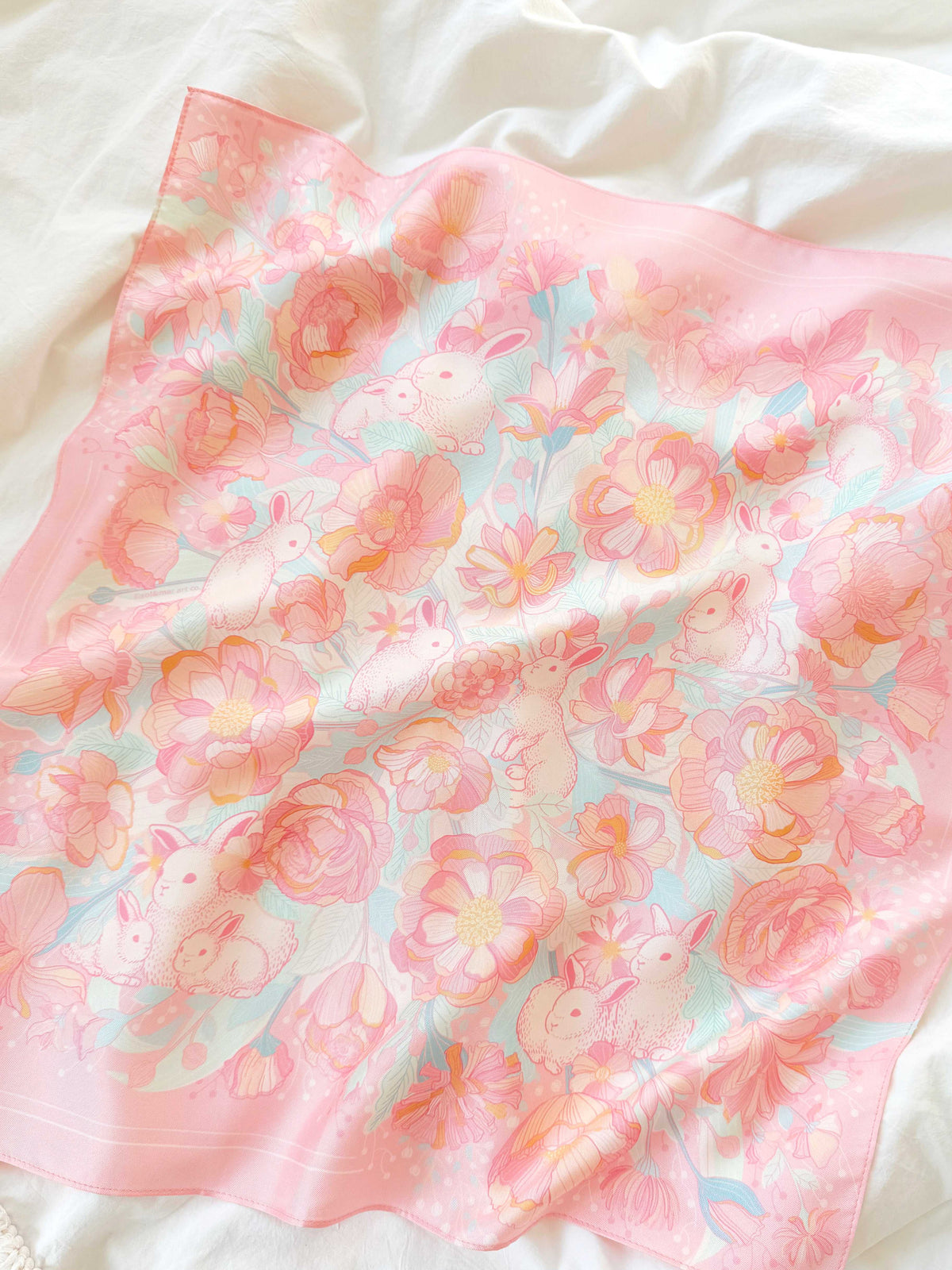 Bunny in the Floral Breeze Silk Twill Scarf featuring pastel bunnies and flowers on a soft pink background.