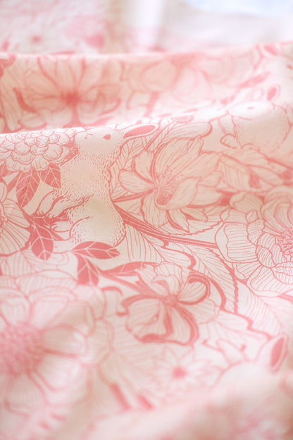 Pastel pink bandana scarf featuring rabbits and floral designs, perfect for hair or pet accessories.