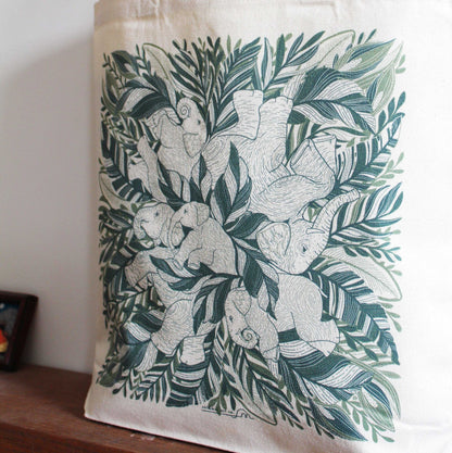 Elephant 'Siesta' canvas tote bag featuring illustrated elephants surrounded by greenery, perfect for everyday use.