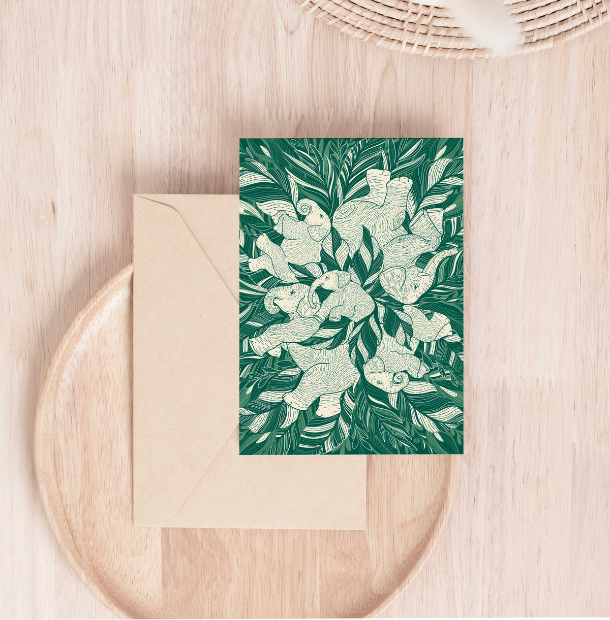 Elephant art greeting card featuring a family of elephants on a green leafy background, perfect for wildlife lovers.