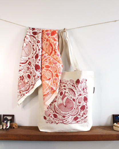 Fox&Berry Canvas Tote Bag with Red fox and berry design, hanging with matching scarves, perfect for everyday use.