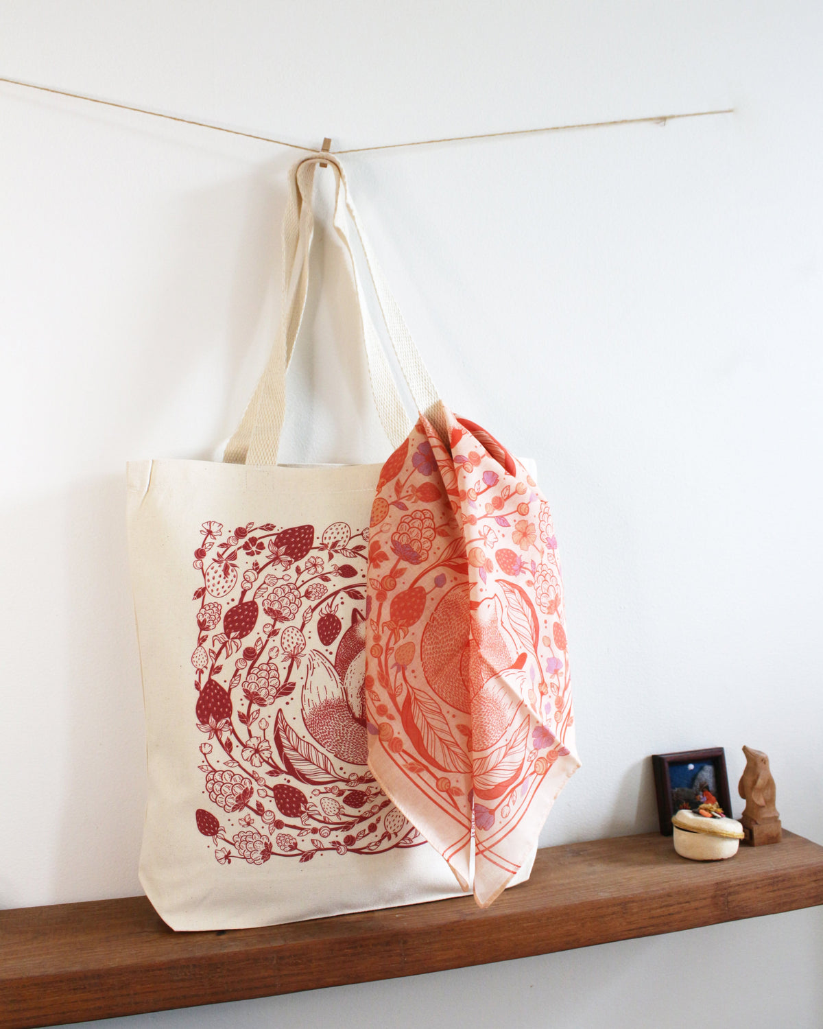Fox&Berry canvas tote bag with red fox and berry art hanging beside a coordinating scarf, perfect for everyday use.