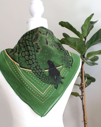 Olive green bandana scarf featuring a giraffe family design, perfect as a hair accessory or pet scarf.