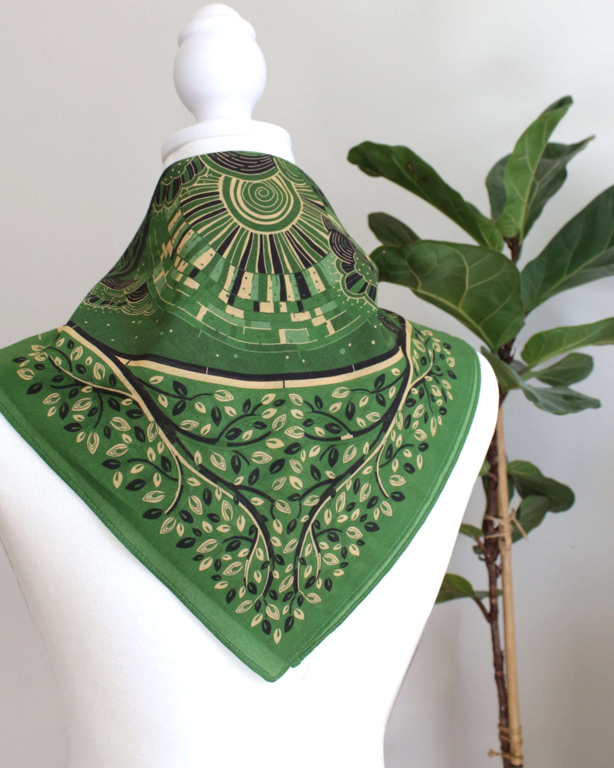 Olive green bandana scarf with artistic pattern, perfect as a hair accessory or pet scarf.