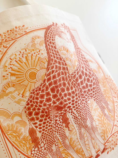 Artistic illustration of two giraffes on a cream tote bag, highlighting Savanna nature and vibrant colors.