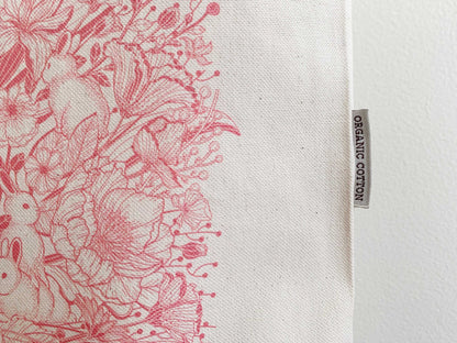 Bunny and floral design on organic cotton canvas tote bag, showcasing vibrant artwork and eco-friendly label.