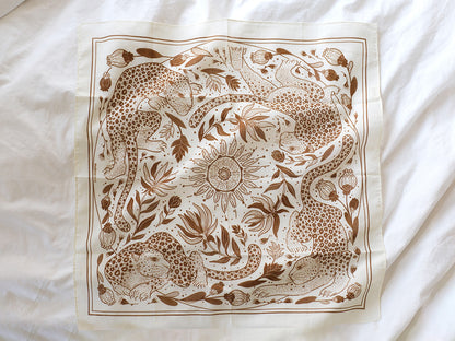 Leopard and the Sun illustrated bandana scarf in off-white with detailed line art design.