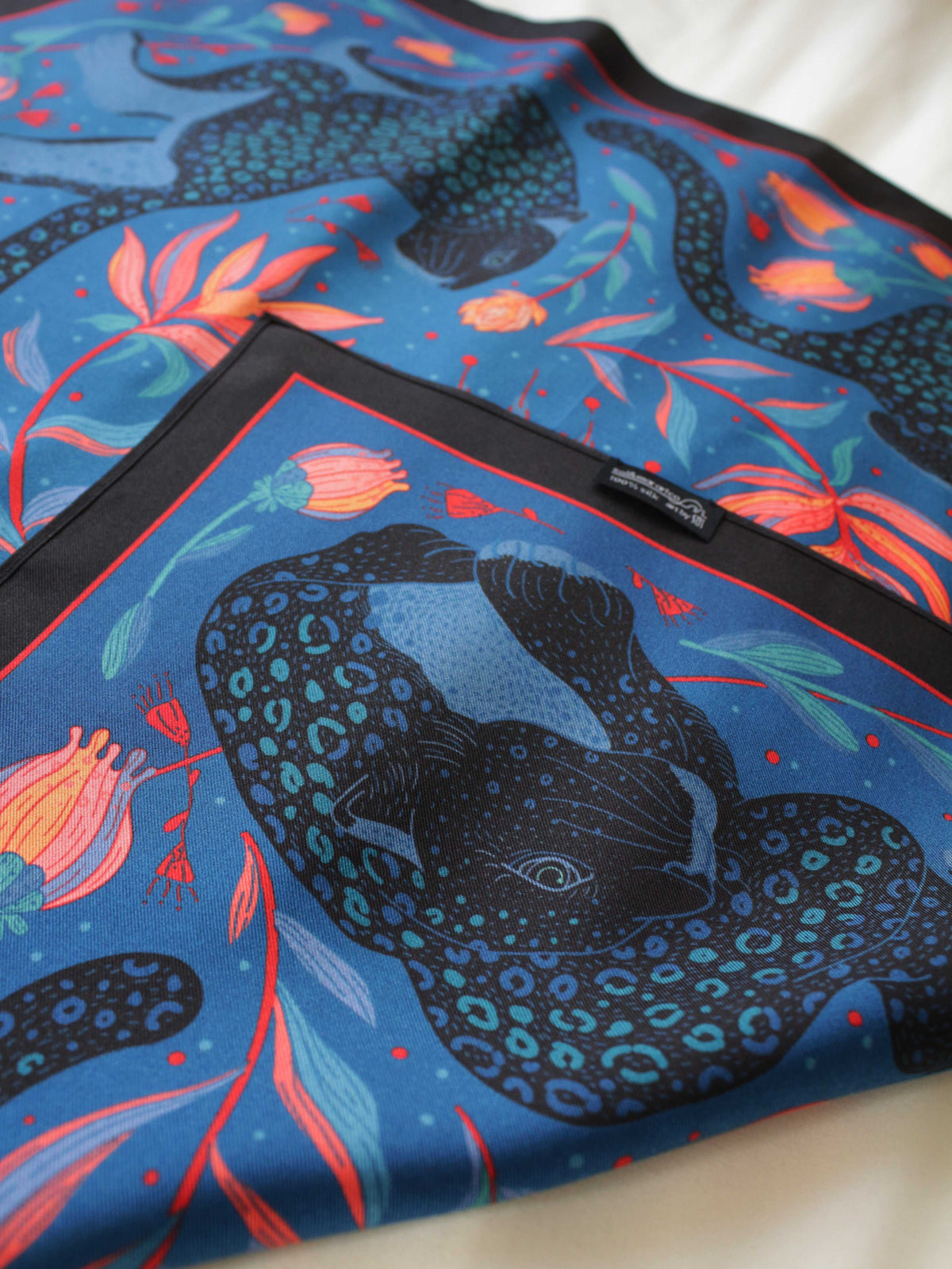 Leopard and the Sun 100% mulberry silk twill scarf featuring vibrant colors and tropical flowers, perfect for versatile styling.