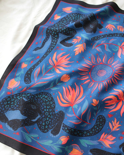 Leopard and the Sun Silk Twill Scarf featuring leopards, sun, and tropical flowers. 100% mulberry silk, 21x21 inches.