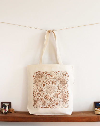 Organic cotton tote bag with intricate leopard and floral line art design, perfect for shopping or everyday use.