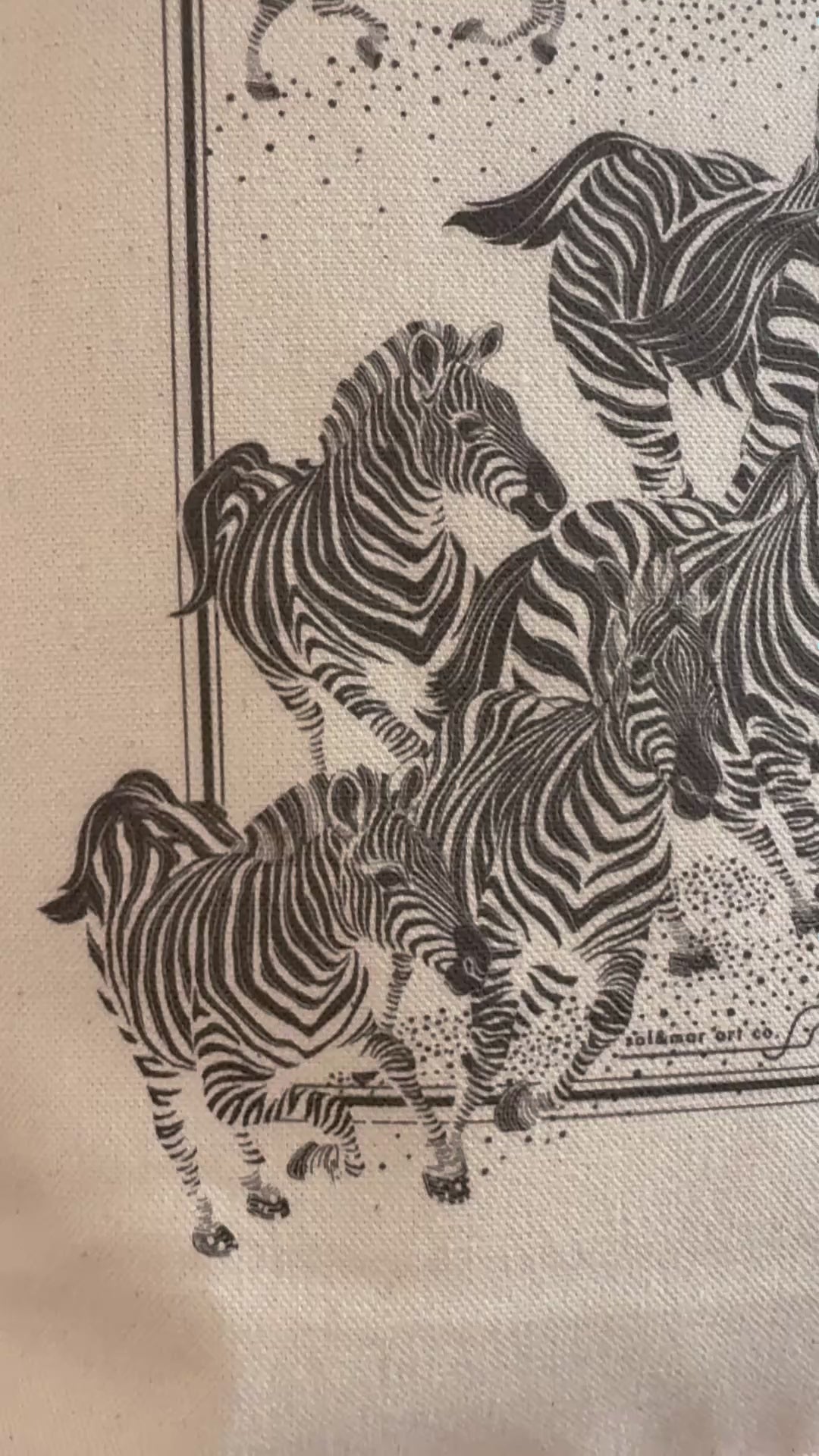 Herd of zebras illustrated on canvas, showcasing detailed black and white zebra art for a stylish tote bag.