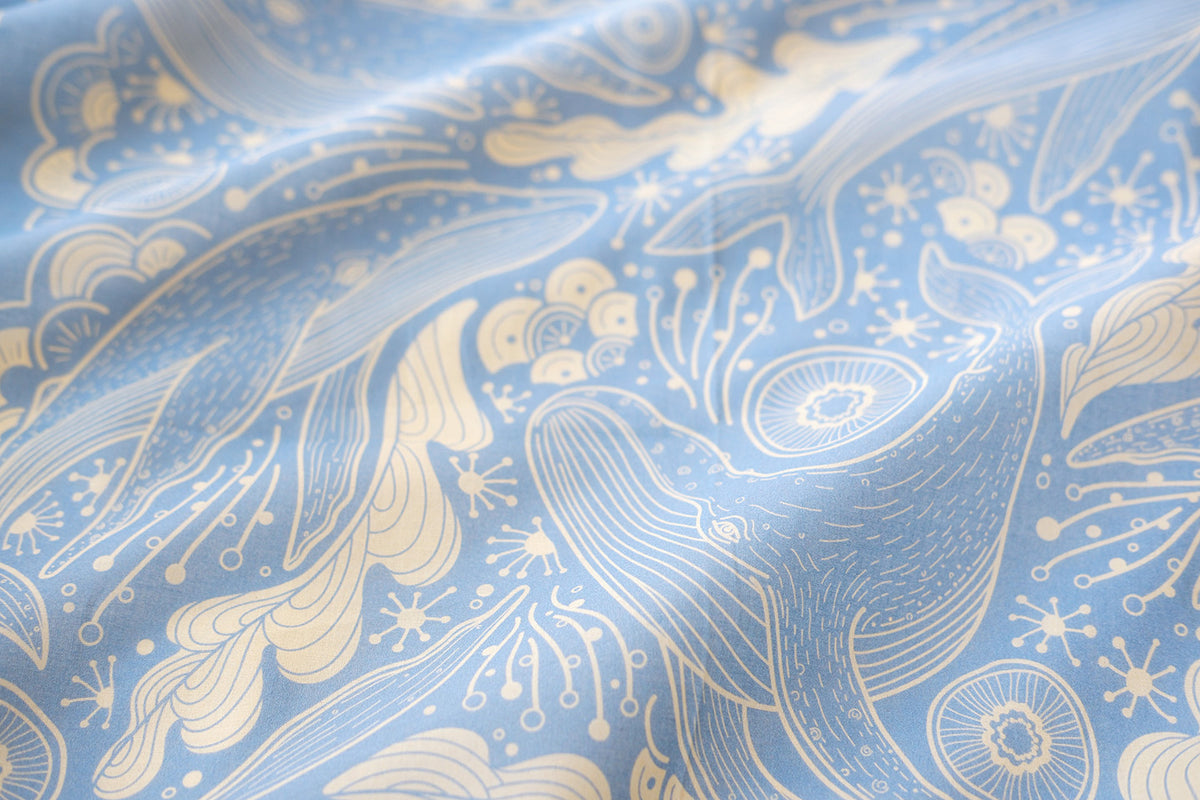 Light blue bandana scarf featuring humpback whales and ocean art, ideal as a hair accessory or decoration.