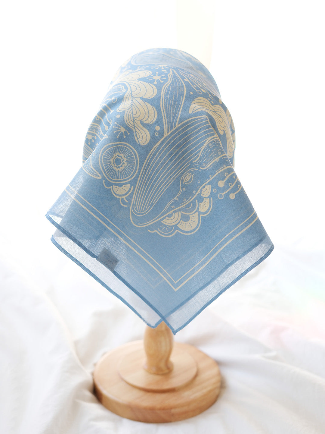 Light blue bandana scarf featuring a Humpback whale and ocean art design, perfect for fashion or decor.