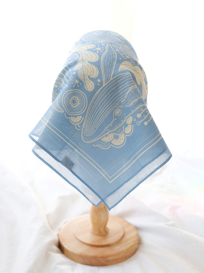 Light blue bandana scarf featuring a Humpback whale and ocean art design, perfect for fashion or decor.