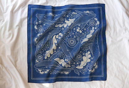 Navy bandana scarf featuring Humpback whales and ocean art design, soft 100% cotton accessory.