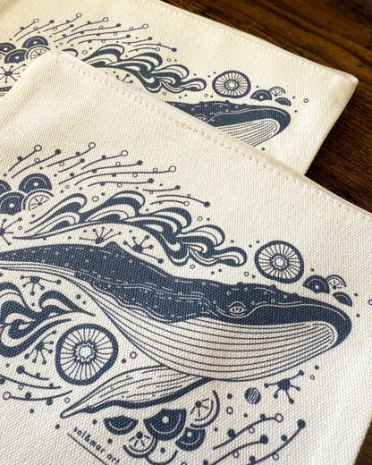 Whale and ocean design on cotton canvas zipper pouch, ideal for cosmetics, pencils, or small items.