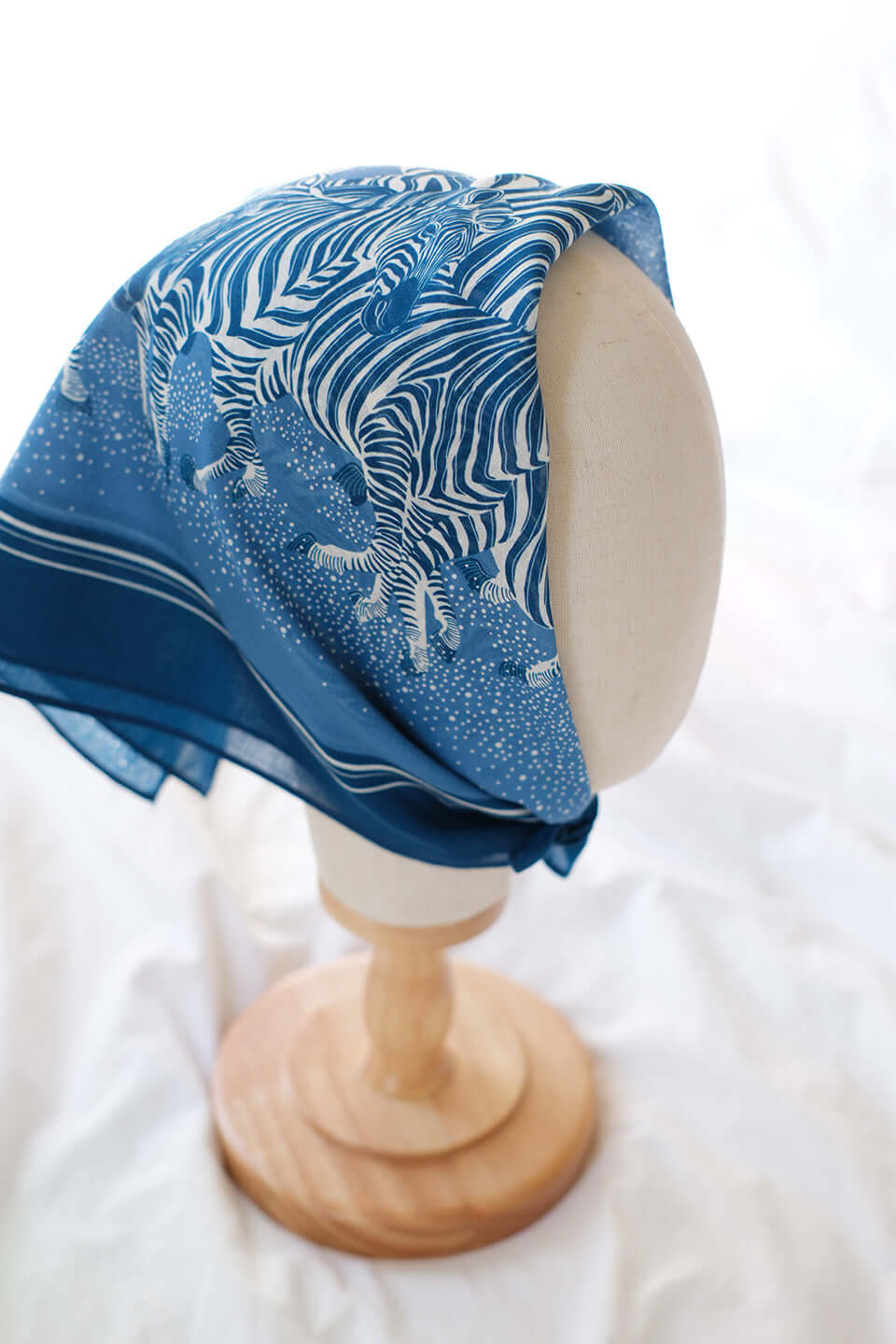Blue bandana scarf featuring a herd of zebras, perfect for hair or accessory styling.