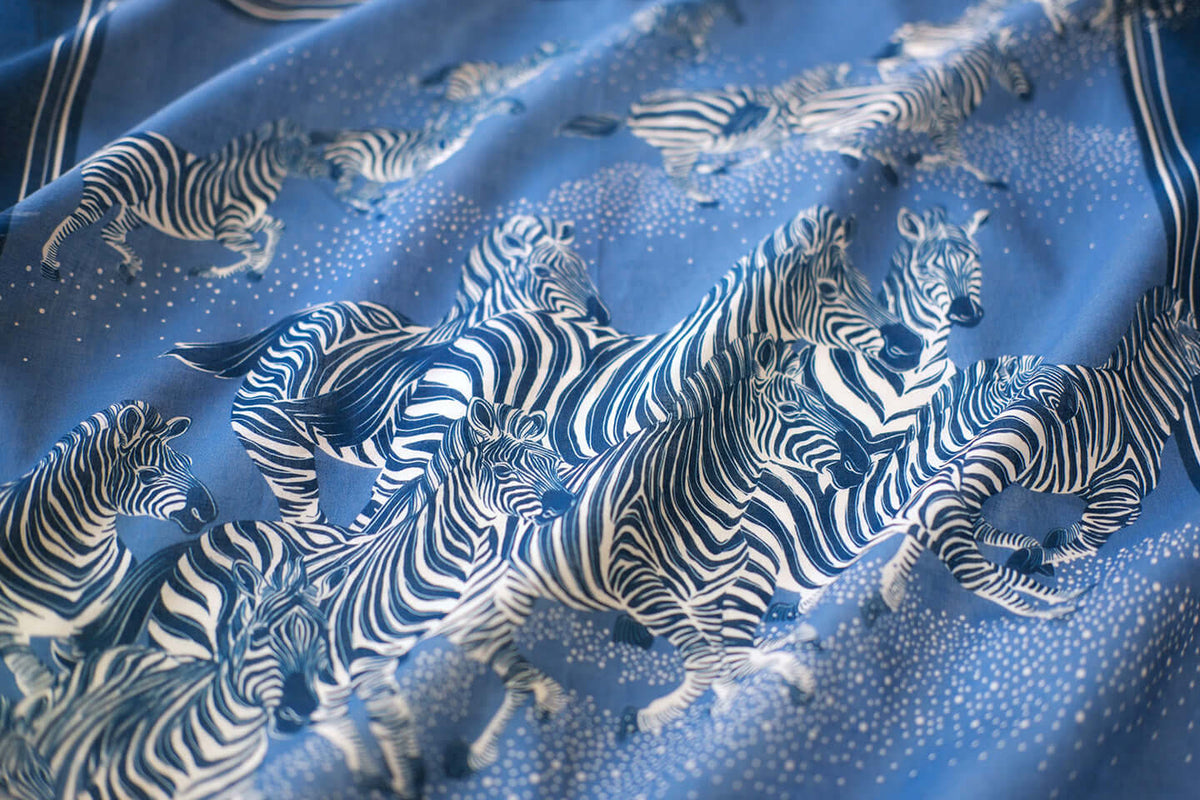 Blue bandana scarf featuring a herd of zebras, lightweight and breathable for versatile use.