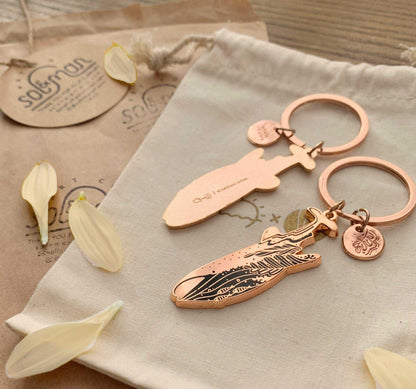 Whale Shark enamel keychain with delicate habitat art, eco-friendly packaging, promoting endangered species awareness.