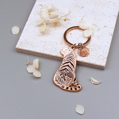 Sunda Tiger enamel keychain showcasing delicate habitat art, with an organic-shaped tag and floral accents.